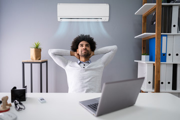 Businessman Working In Office With Air Conditioning
