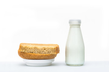 A nutritious breakfast of bread and eggs with milk, garnished with a green leaf.