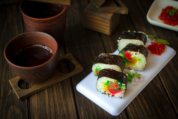 Fototapeta na wymiar Traditional fresh japanese sushi rolls, black wooden table