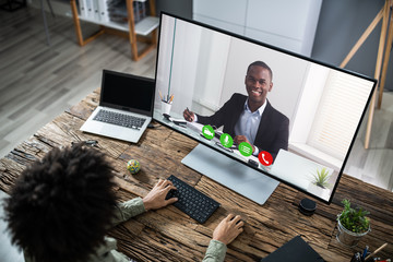 Businessman Video Conferencing With Coworkers On Computer