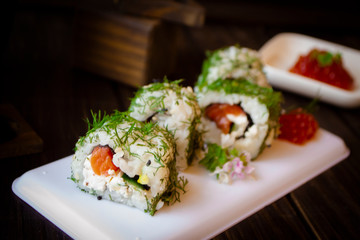 Delicious sushi rolls with tuna and cream cheese in chopped dill