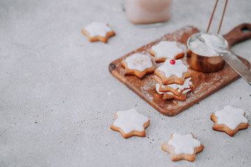 Fototapeta na wymiar Homemade Christmas star shape gingerbread cookies with frosting.