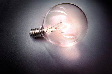 Stand alone light bulb on gey background