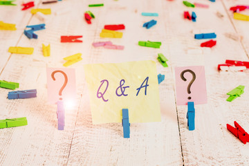 Word writing text Q And A Question. Business photo showcasing in which demonstrating asks questions and another one answers them Scribbled and crumbling sheet with paper clips placed on the wooden