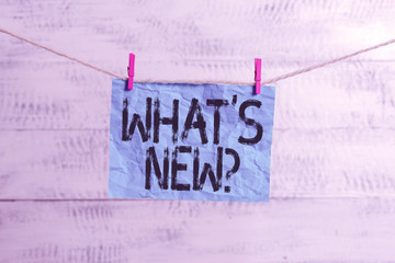 Text sign showing What S New Question. Business photo text when you ask someone about his current live events actions Clothesline clothespin rectangle shaped paper reminder white wood desk