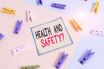 Conceptual hand writing showing Health And Safety Question. Concept meaning regulations and procedures to prevent accident or injury Colored clothespin paper reminder with yellowblue background