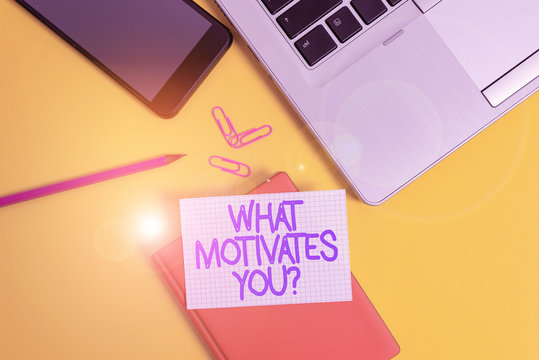 Conceptual hand writing showing What Motivates Youquestion. Concept meaning know reasons why you want to wake up each morning Laptop smartphone clip pencil paper sheet colored background