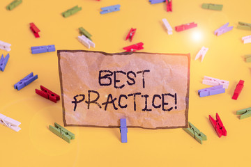 Handwriting text writing Best Practice. Conceptual photo commercial procedures accepted prescribed being correct Colored clothespin papers empty reminder yellow floor background office