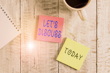 Text sign showing Let S Discuss. Business photo showcasing asking someone to talk about something with demonstrating or showing Stationary placed next to a cup of black coffee above the wooden table