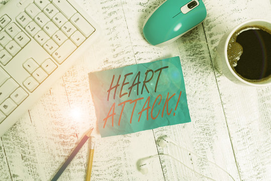 Handwriting text writing Heart Attack. Conceptual photo sudden occurrence of coronary thrombosis resulting in death technological devices colored reminder paper office supplies keyboard mouse