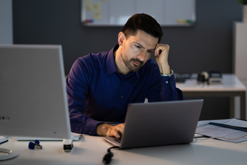 Stressed Accountant Working Late In Office