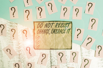 Writing note showing Do Not Resist Change Embrace It. Business concept for Be open to changes try new things Positive Scribbled and crumbling papers with thick cardboard above wooden table