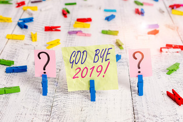 Word writing text God Bye 2019. Business photo showcasing express good wishes when parting or at the end of last year Scribbled and crumbling sheet with paper clips placed on the wooden table