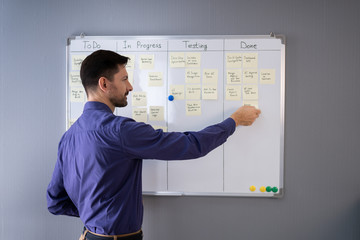 Businessman Writing On Sticky Notes