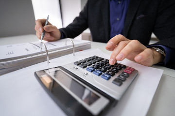 Businessman Using Calculator