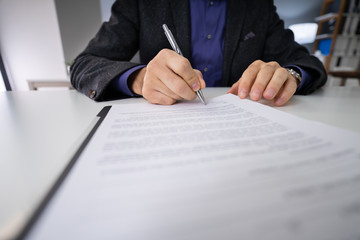 Close-up Of Businessman Holding Pen