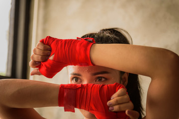 Fototapeta premium Young women practicing kickboxing in the gym.