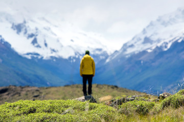 A hiker man looks over the mountains in El Chalten, Patagonia, Argentina