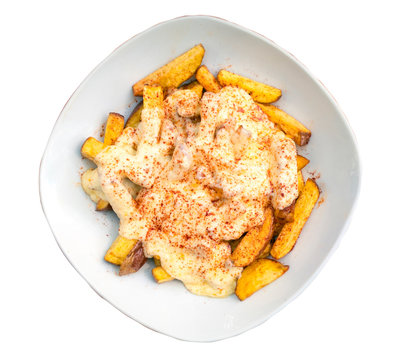 Tasty french fries covered with creamy cheese and paprika on a white background. Top view, isolated