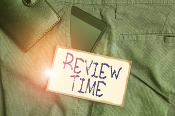 Handwriting text writing Review Time. Conceptual photo to think or talk about something again Set schedule to review Smartphone device inside trousers front pocket with wallet and note paper