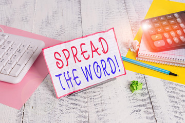 Conceptual hand writing showing Spread The Word. Concept meaning share the information or news using social media Notepaper on wire in between computer keyboard and sheets