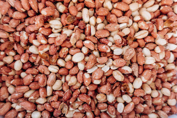 Closeup image of salted peanuts as a food background