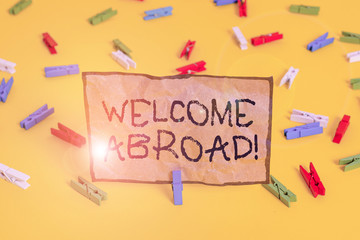 Handwriting text writing Welcome Abroad. Conceptual photo something that you say when someone gets on ship Colored clothespin papers empty reminder yellow floor background office