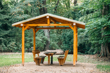 Covered seating area. Gazebo, pergola in parks and gardens - relax and unwind. Wooden gazebo in the Park - obrazy, fototapety, plakaty