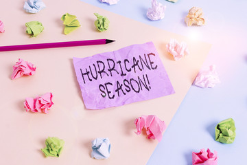 Fototapeta na wymiar Writing note showing Hurricane Season. Business concept for time when most tropical cyclones are expected to develop Colored crumpled papers empty reminder blue yellow clothespin