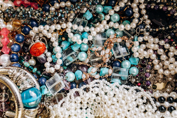 Beads and necklaces made of colored semi precious stones. Background from a variety of beautiful...