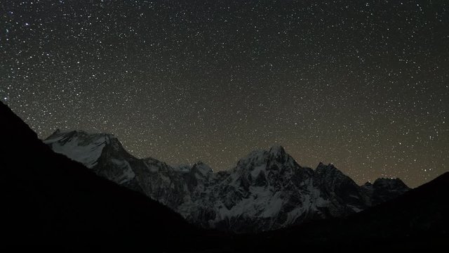 Time lapse of stars and moonrise over mountain peaks of Himalayas, Manaslu region, Nepal
