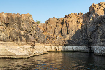 Fototapeta na wymiar Rock cliffs along the banks of the Nile river in Aswan