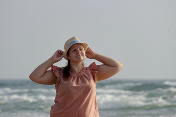 Girl fooling around near the water from a happy vacation.