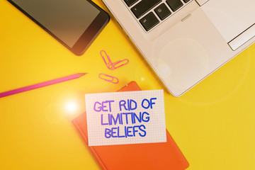 Conceptual hand writing showing Get Rid Of Limiting Beliefs. Concept meaning remove negative beliefs and think positively Laptop smartphone clip pencil paper sheet colored background
