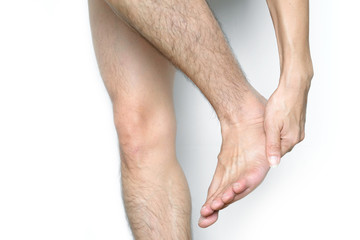 Picture of a male leg And the man's hand, he caught his ankle Pain in the ankle