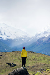 Fototapeta na wymiar A hiker woman looks over the mountains in El Chalten, Patagonia, Argentina