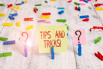 Writing note showing Tips And Tricks. Business concept for means piece advice maybe suggestion how improve Crumbling sheet with paper clips placed on the wooden table