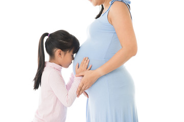 Pregnant woman and a Daughter hugging