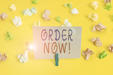 Conceptual hand writing showing Order Now. Concept meaning confirmed request by one party to another to buy sell Colored crumpled paper empty reminder white floor clothespin