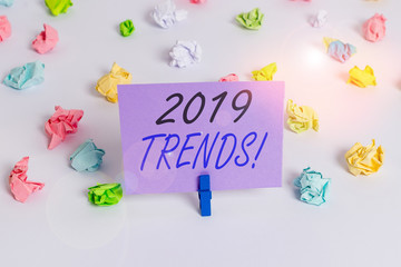 Handwriting text writing 2019 Trends. Conceptual photo general direction in which something is developing or changing Colored crumpled papers empty reminder white floor background clothespin