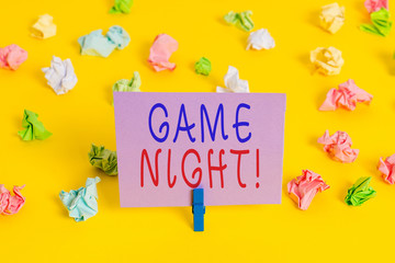 Conceptual hand writing showing Game Night. Concept meaning usually its called on adult play dates like poker with friends Colored crumpled paper empty reminder white floor clothespin