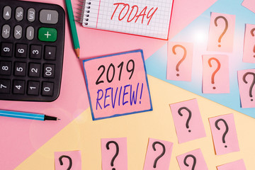 Word writing text 2019 Review. Business photo showcasing remembering past year events main actions or good shows Mathematics stuff and writing equipment above pastel colours background