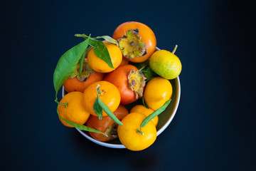 A bowl of fruit on blue background