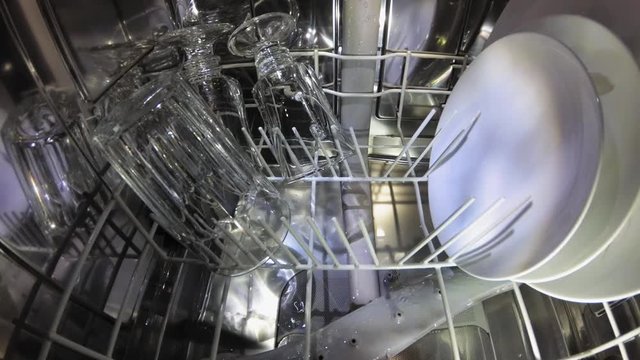Dishwasher Interior During Washing Dishes and Glasses POV