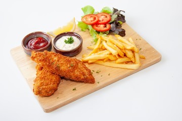 Fish and chips menu, Two pieces of deep fried fish on wooden plate with french fries on white...