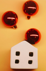 White toy house with red Christmas balls. Lush Lava background. Celebrating New Year. Chinese New...