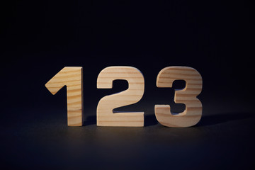 wooden numbers 123 on a black background