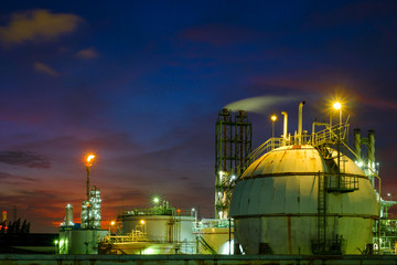 Gas storage sphere tanks and pipeline in oil and gas refinery industrial plant at twilight