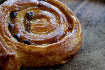Rum denish on wood tray served with hot coffee, popular drink and bakery, high sugar and trans fat caused serious chronic disease such as diabetes.