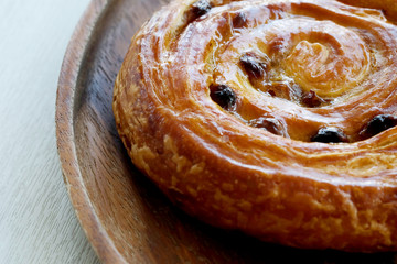 Rum denish on wood tray served with hot coffee, popular drink and bakery, high sugar and trans fat caused serious chronic disease such as diabetes.